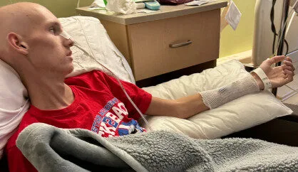 Britt in hospital bed during cancer treatment